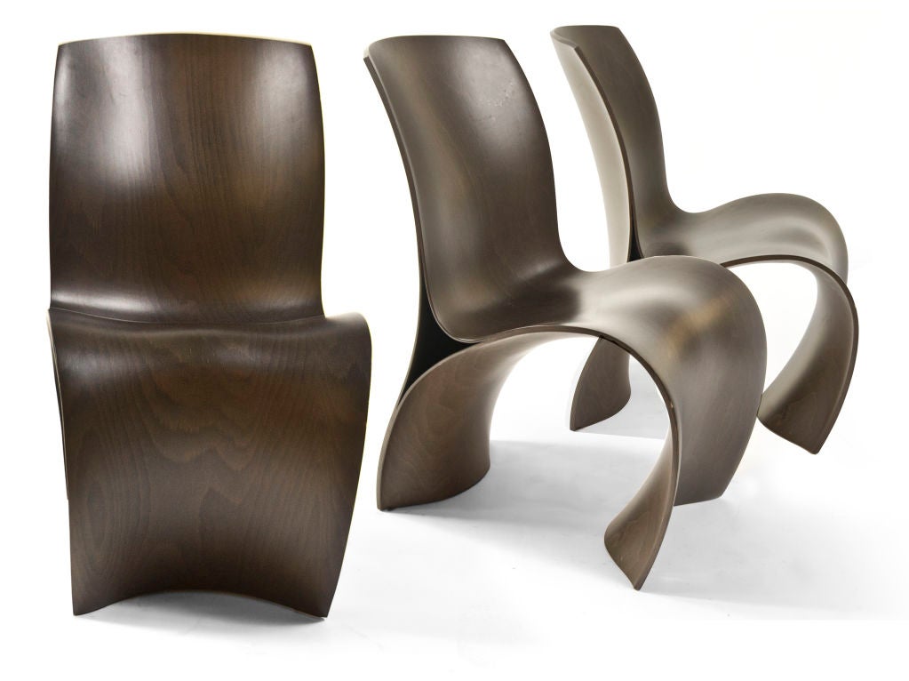 The Three Skin Chair was designed by Ron Arad for moroso in 2004, is made of molded beech plywood, making it powerfully sculptural and extremely sinuous, covered dark wood grain finish.