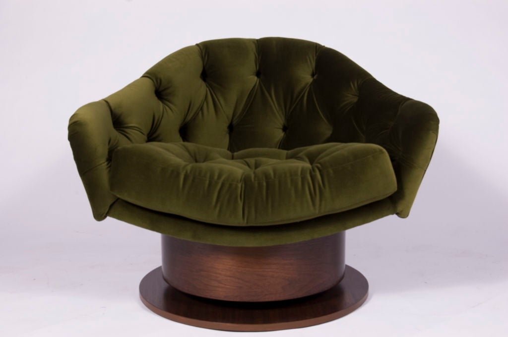 Barrel-back form club chair splayed open armed tufted seat upholstered in dark green silk velvet on a round polished wood veneer swivel base. COM Available, lead time 6-8 weeks.