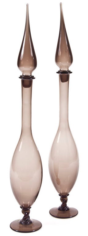 Pair of tall hand blown smoked Murano glass decanters with pointed lids.