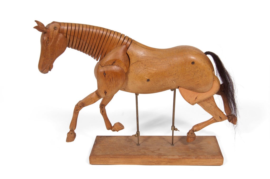 Hand carved oak artist’s model mannequin on two brass rods. Articulated neck and joints with horse hair tail.