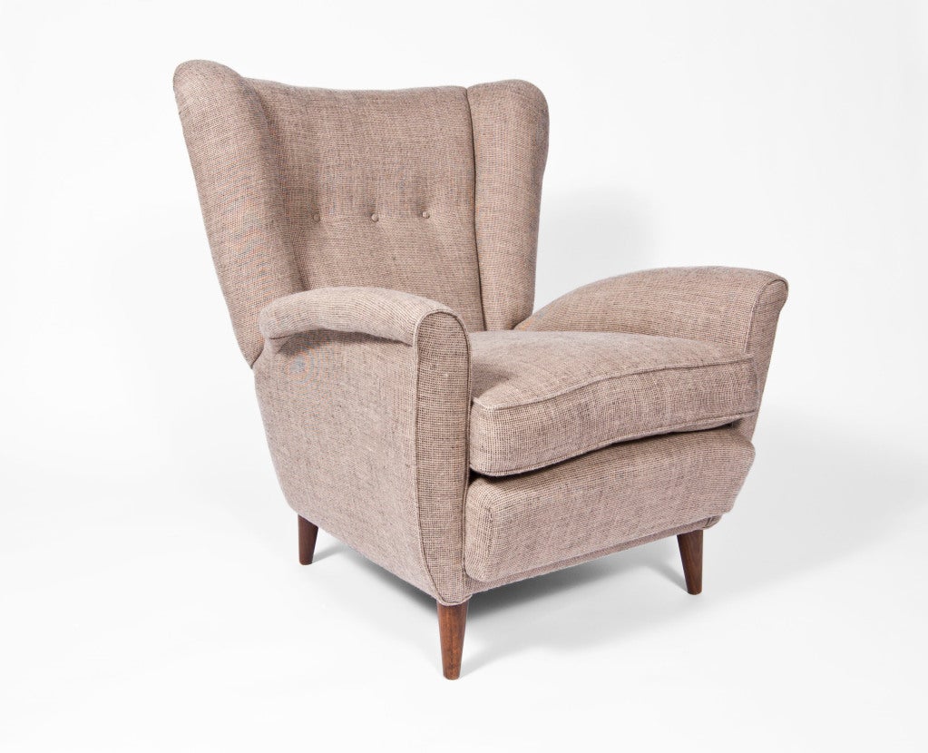 Pair of large club chairs with curled arms and square tapered legs upholstered in Irish linen with three button back.
