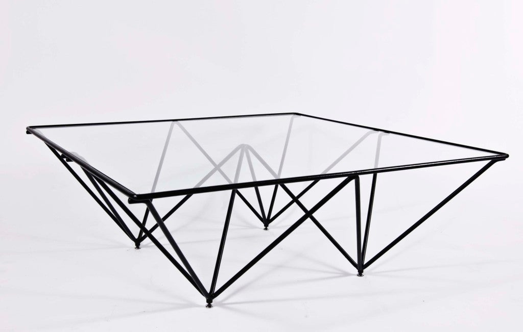 Steel rods welded in four joining tetrahedrons with inset square glass top. Designed by Paolo Piva for B&B Italia.
