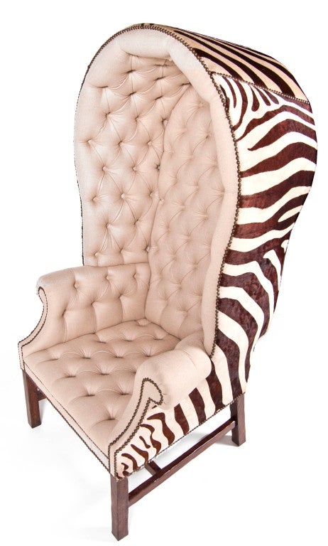 Hooded wing chair with domed crown. Rolled arms with nail head trim on provincial legs with stretcher and tufted interior. COM/COL Available 6-8 Week Lead Time.