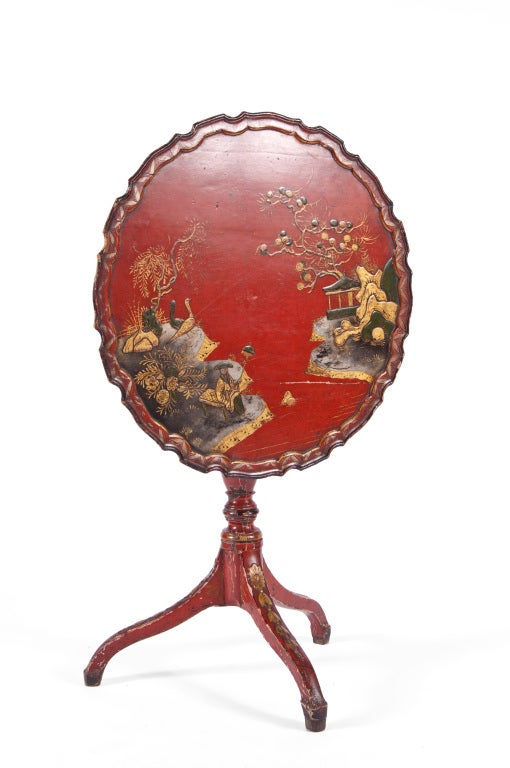 Tilt top serving table in red lacquer, hand painted Chinoiserie scene, routed edges, lathed base on tripod spider legs.

All Sales Final - No Additional Discount