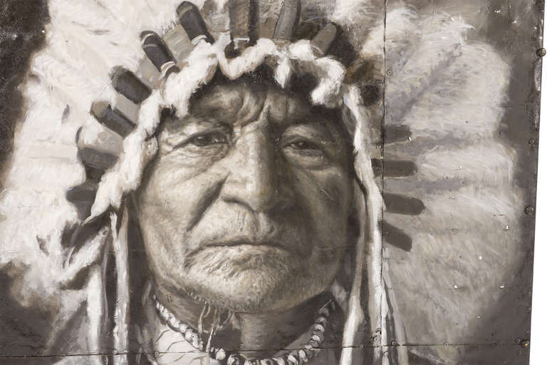 Painting of Native American Chief in full head-gear on several panels of riveted sheet metal.