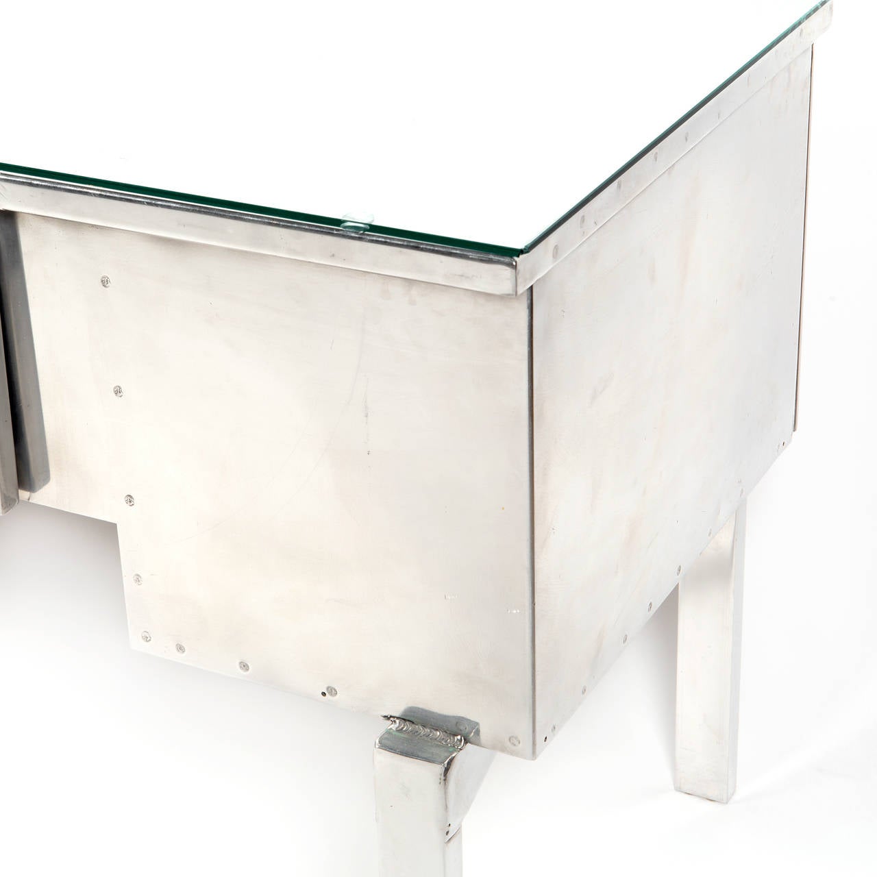 Desk made from aircraft aluminum during 1930's-40's and would have been used in European and Pacific theatres during the war. Interior drawers have green paint that used to cover the entire desk. Desk has been stripped to reveal original aluminum