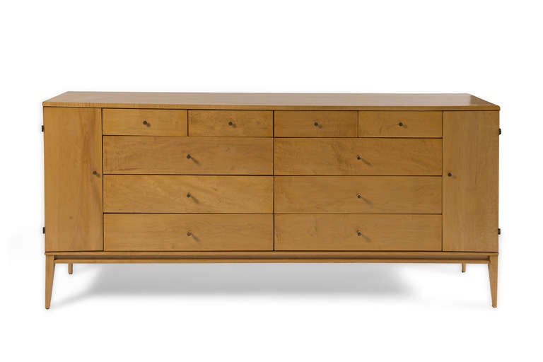 Bleached maple ten drawer chest with two side cabinets.