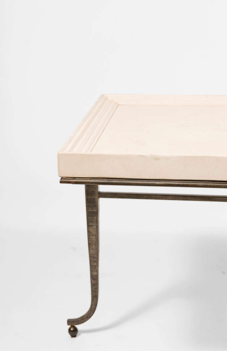 Marble tray top table on forged three legged base with brass feet.