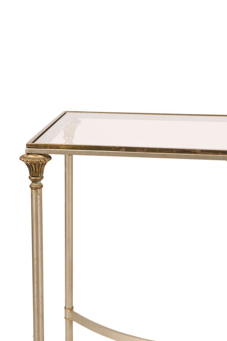 Steel and brass console table with brass floral accents, inset glass top.