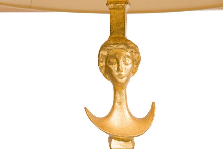 Gilded bronze figural lamps on outstepped round base.