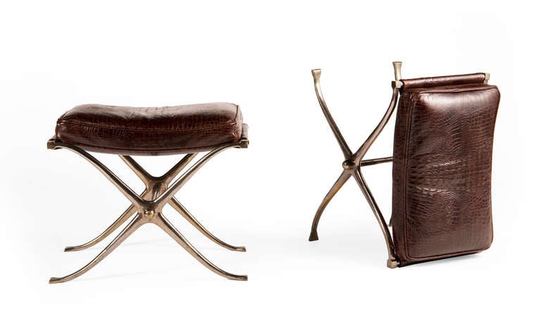 Pair of X-form campaign style stools, chromed steel base with leather straps and loose leather seat cushion.
