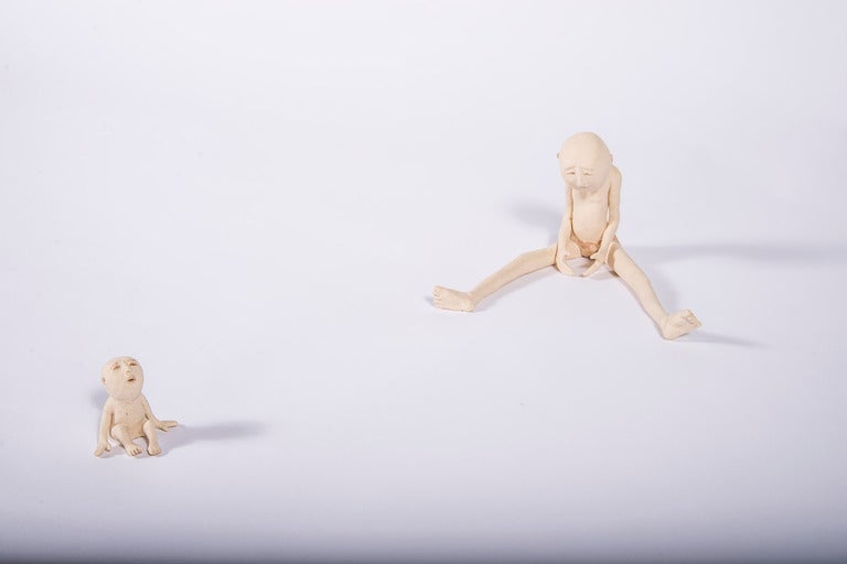Two figures, one parent and child.
