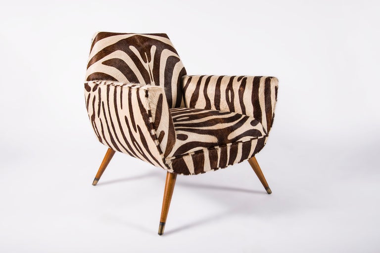 COUP Studio armchair in alder with splayed and capped feet, rounded frame, deep seat, self welt upholstered in faux Zebra hair on hide. COM Available. 8-10 week lead time. 