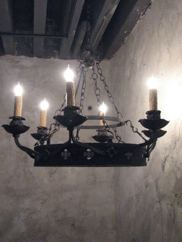 Chandelier Late 19th century six-arm iron rewired American with wax candle sleeves.