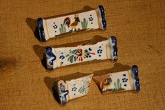 Three Faience Knife Rests one broken