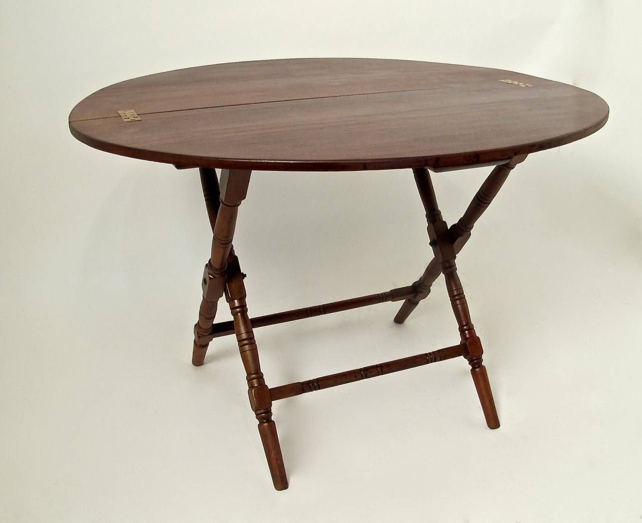 Campaign style walnut oval shaped folding table. 
Late 19th century, England.