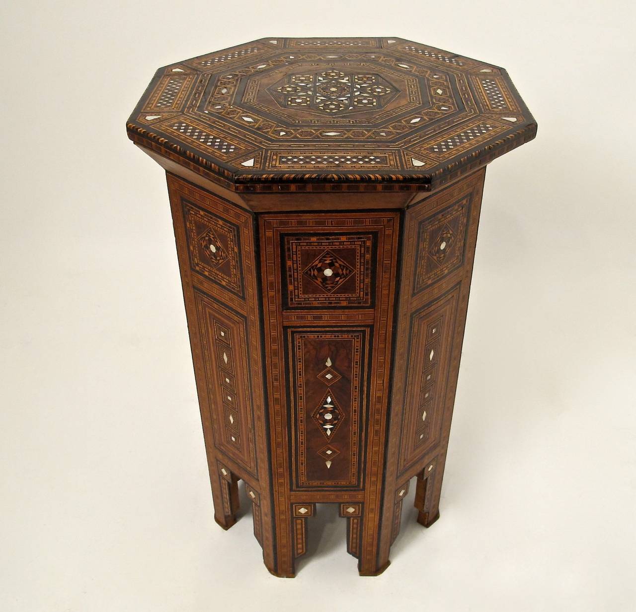 Octagonal shape side table with elaborate inlaid woods, mother-of-pearl and ebonized detail, Syria, late-early 20th century.