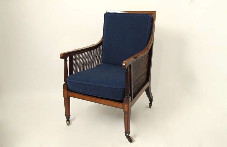 George III style caned and upholstered arm chair. Mahogany with Satinwood inlay detail. Cushions are in excellent condition and ready for reupholstering.