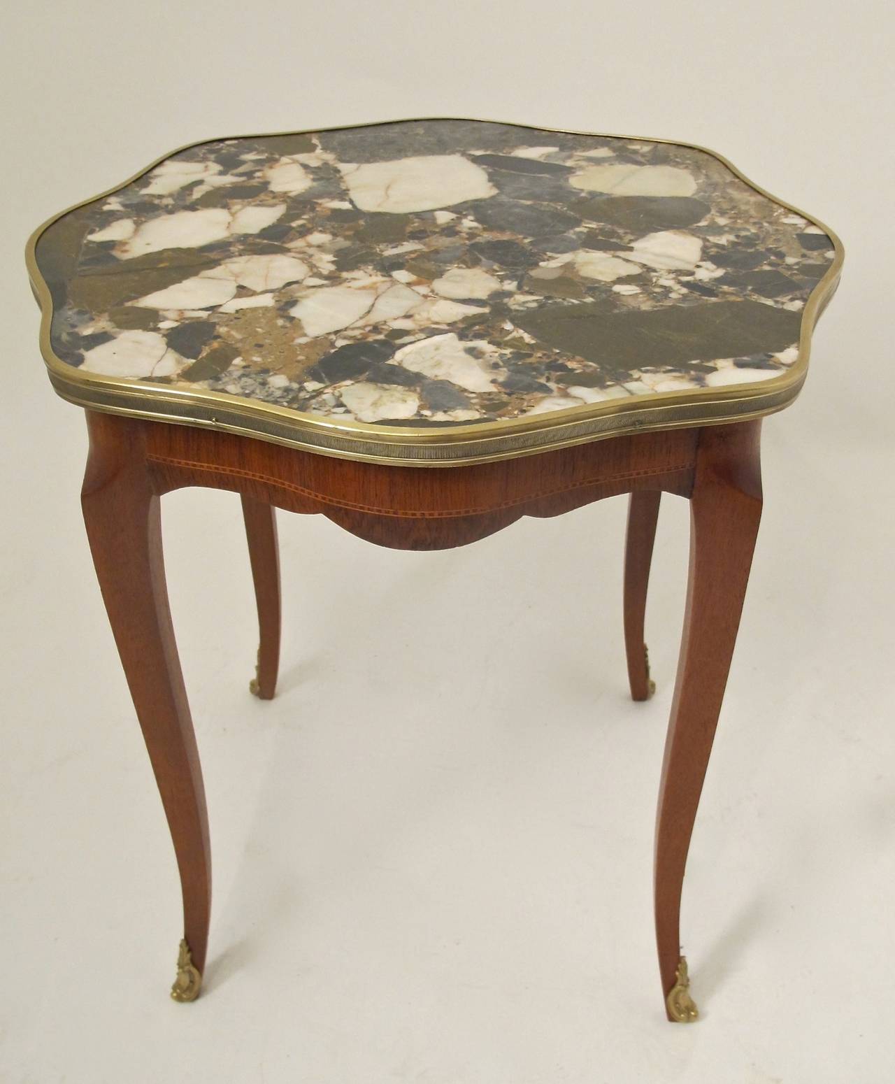 Italian Breche de Alp marble-top table with brass trimmed edge on cabriole legs with brass sabots. Mahogany with satinwood inlay. Italian, 1950s.