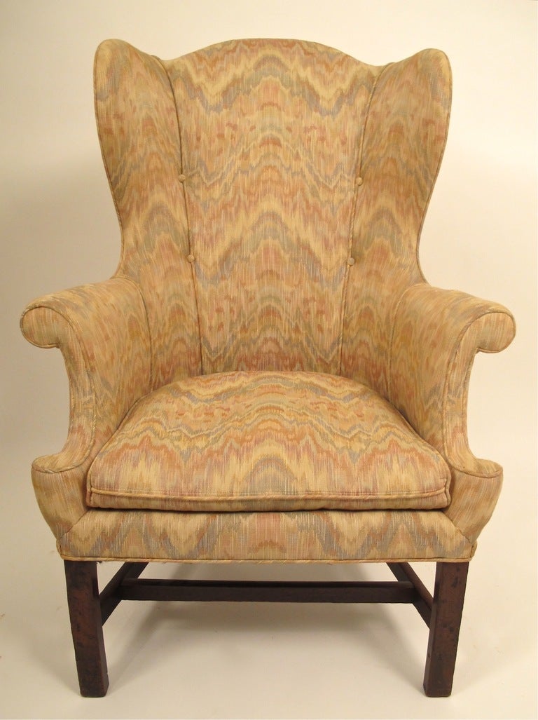 An unusual form and small-scale 18th century wing chair, custom-made size (most likely for a woman). Continental European (most likely England or there about). Upholstery is dated and lightly worn.