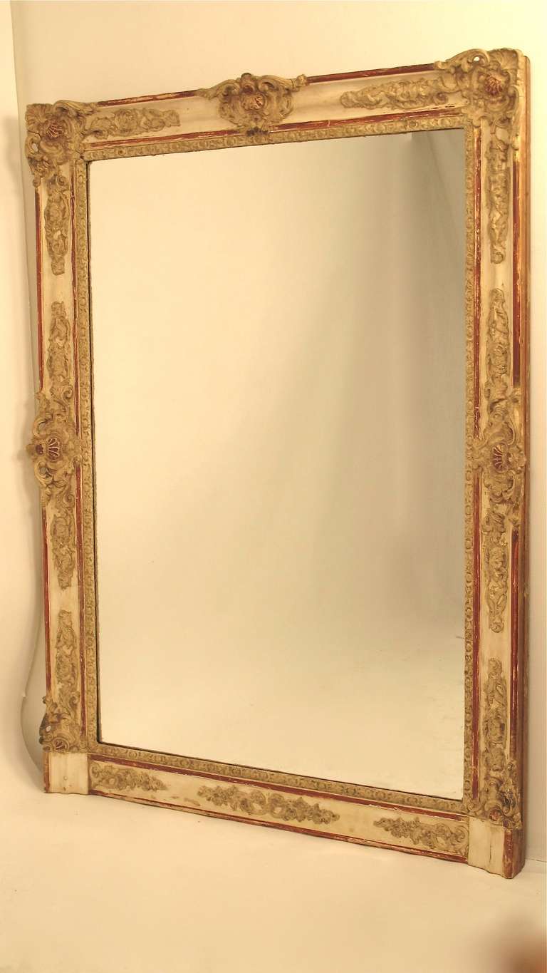 A large scale over mantle mirror with good original crusty paint. France, early to mid 19th century.