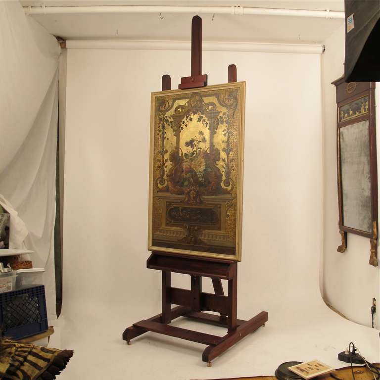 Large painting easel on copper casters (wheels), recently refinished.