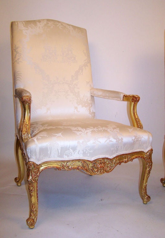 A matched pair of carved and gilt armchairs. These chairs are very generous in size, very comfortable and excellent quality. Silk fabric is in slightly worn condition, France, late 19th century.