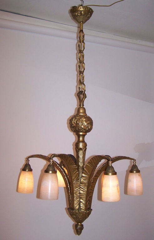 An exuberant Art Deco period bronze palm leaf chandelier with six cone shaped hanging alabaster shades. 
European, 1920's-1930's.  
Recently refurbished and rewired.  
