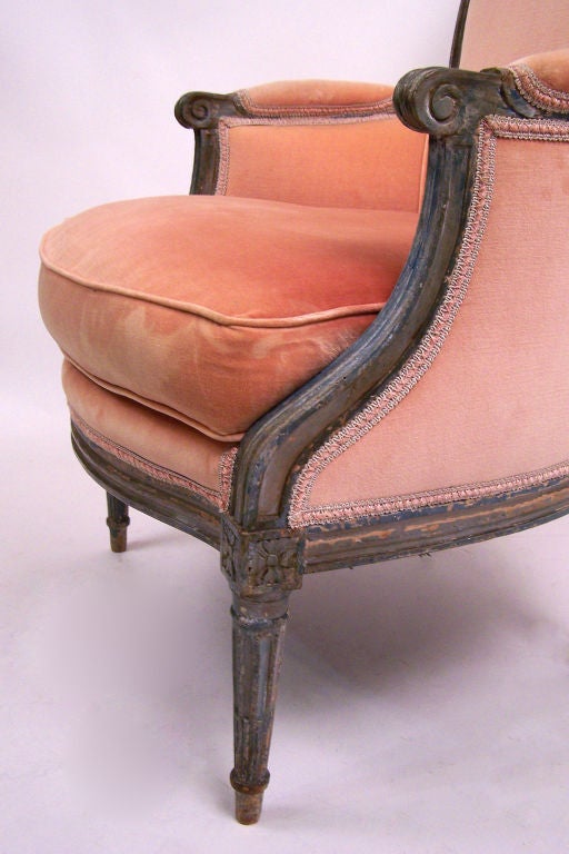 Carved and painted frame with peachy velvet upholstery.