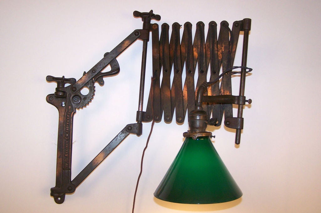 Early 20th century American lamp with original copper flashed hardware and period emerald lite shade. Stamped W.D. Allison Co. Indianapolis. Multiple adjustments, expands to 6 plus feet
