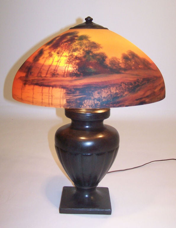 Handel lamp with original reverse painted shade. Has original cloth label on the bottom of the base and is signed on the shade and also signed in the heat ring. American, early 20th century.