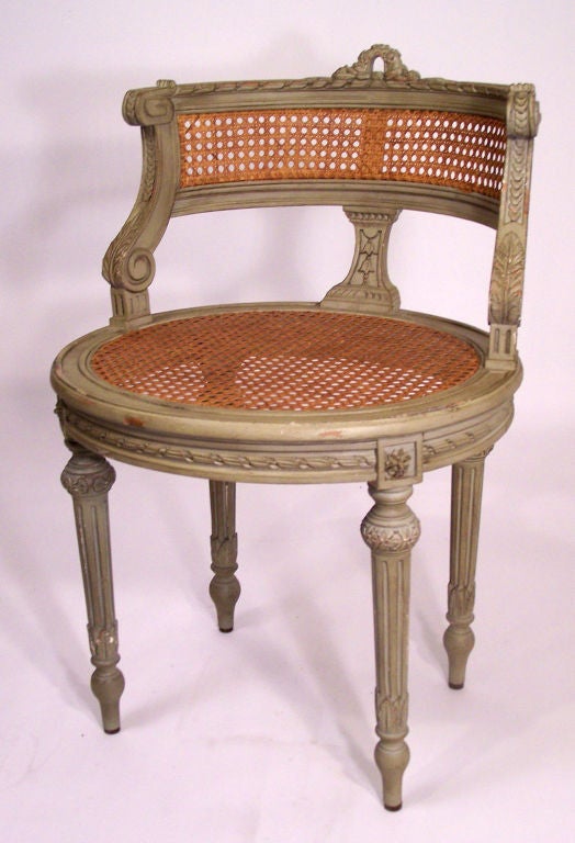 Small carved and painted wood chair with caned seat and back,  perfect for a vanity or bedroom.