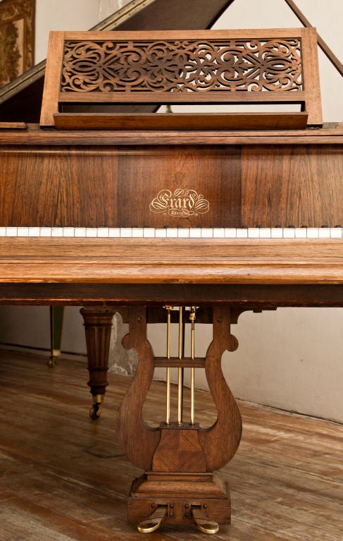 Fine quarter paneled rosewood Erard piano raised up on Louis XVI supports.<br />
History: The House of Erard along with Pleyel and Gaveau was the most<br />
sought after piano maker in France with many special commissions to<br />
the English