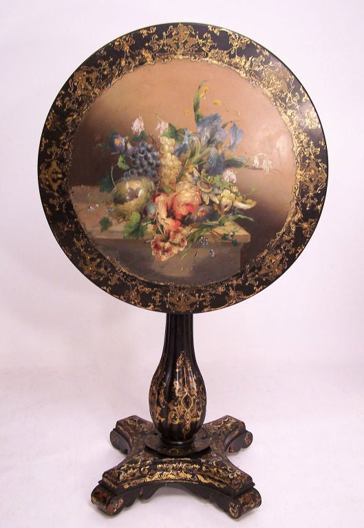 Extraordinary detailed design on this papier mache and black lacquer tilt top table. Beautiful floral still life painting and inlaid mother of pearl and gilt detail. France, 19th century.