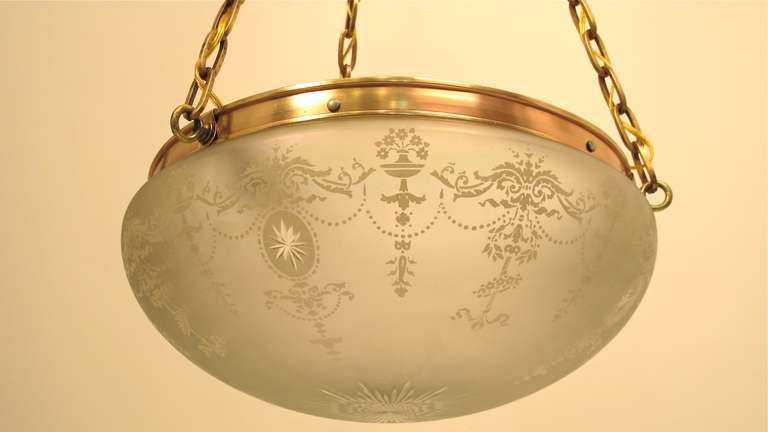 A fine quality frosted and etched iridescent glass bowl with reddish bronze hanger and hardware. Reconditioned and restored. American, circa 1910.

The lamp is 20 inches in diameter, and the bowl is 7.5 inches at the deepest point.  Currently the