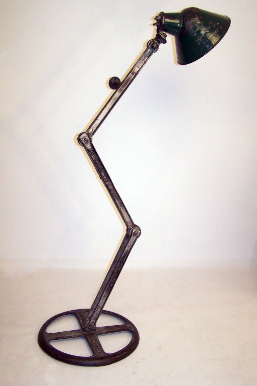 A vintage articulated industrial floor lamp with enamel shade. Made by the Save-Lamp Co. Baltimore MD.