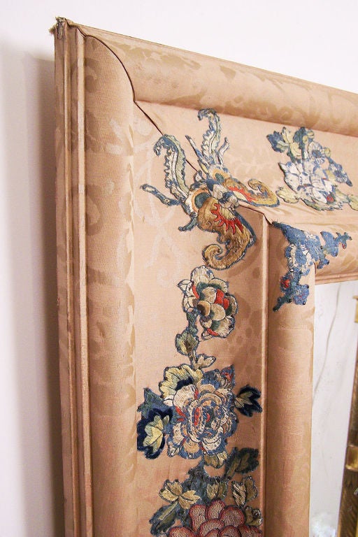 Custom made silk damask upholstered mirror with 19thC Chinese embroidery applied to the concave sides. Stepped bull nose around the outside and inside edges. This mirror is square shaped and a nice large size.