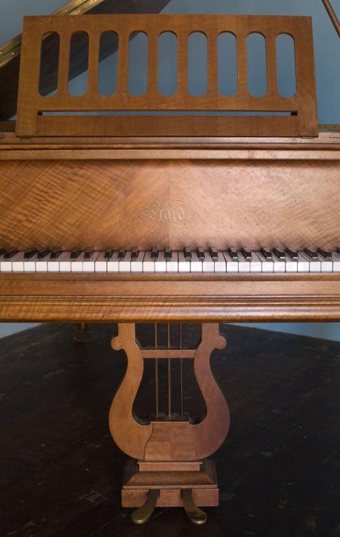 Fine quarter paneled walnut grand piano with Louis XVI supports.<br />
Provenance: Private collection Paris