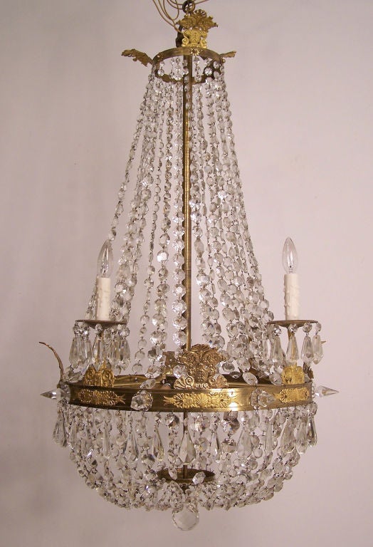 A nice large size cut crystal chandelier with gilt bronze ornamentation. Recently re-wired. France, late 18th/early 19th century (1790-1825).