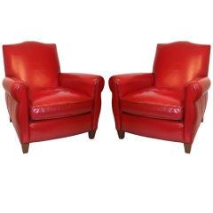 A Pair of Red Leather Club Chairs and Ottoman