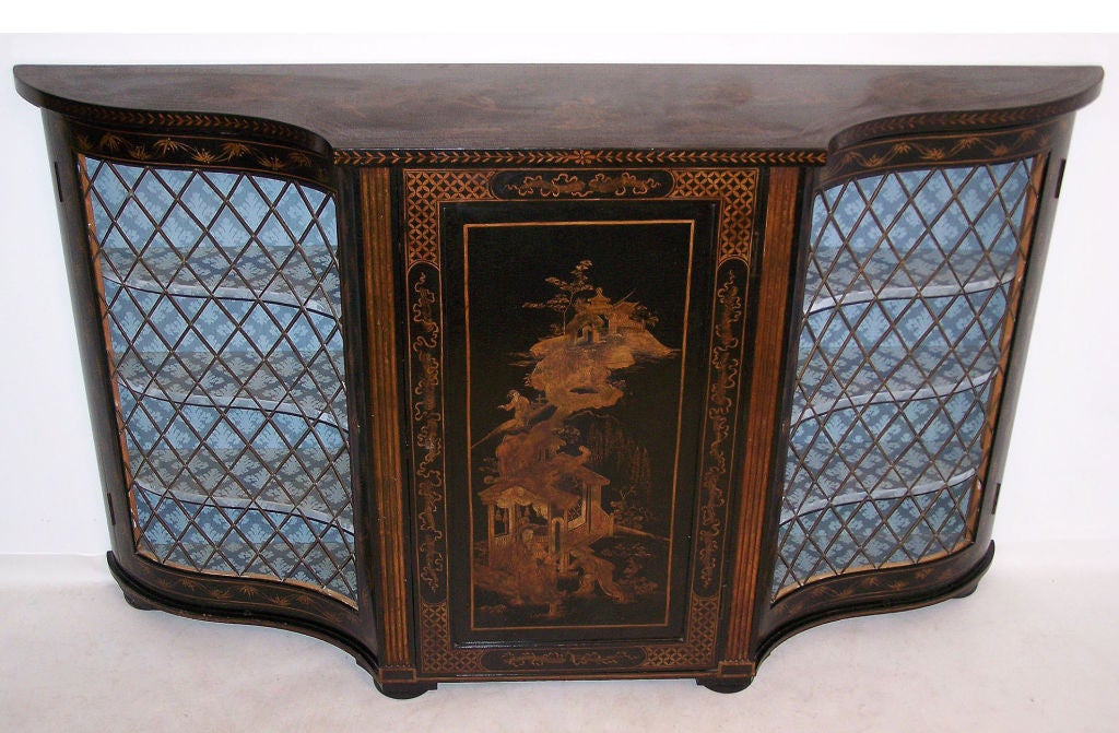 Beautifully hand-painted, ebonized and gilt console cabinet with bronze grates on the side doors. The center door opens and is fitted with adjustable shelves. High quality cabinet in the manner of Maison Jansen.
