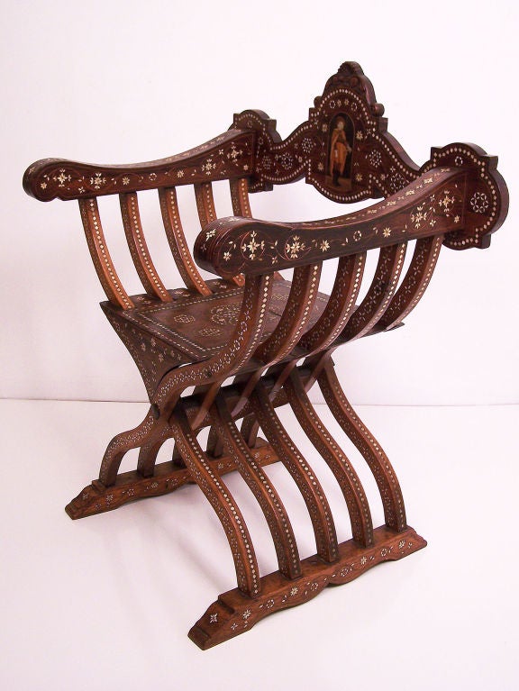 An elaborately inlaid Renaissance style Dante or X chair. Cavalier figure on the back is inlaid with bone and mixed woods. Great detail and good patina. Italian, Late 18th. Century.