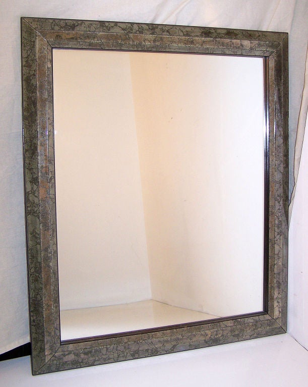 An exceptionally nice quality Italian mirror. Marbleized mirror frame with all edges beveled, and having an ebonized wood trim around the outside. Italy, mid 20th century.