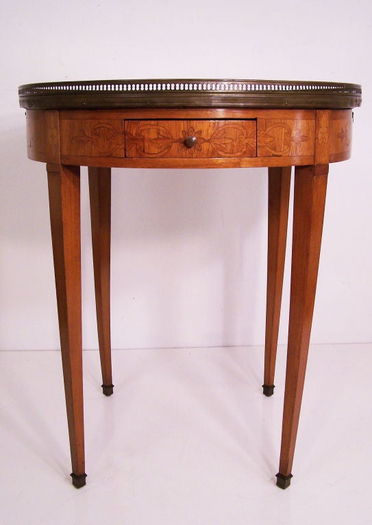 Mixed fruitwood bouilliotte table with brass hardware and rouge marble top. France, early to mid 20th century.