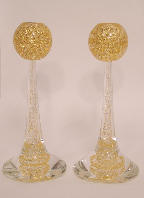 A beautiful pair of Italian glass candlesticks with gold flecks. Signed on the bottom Cenedese.