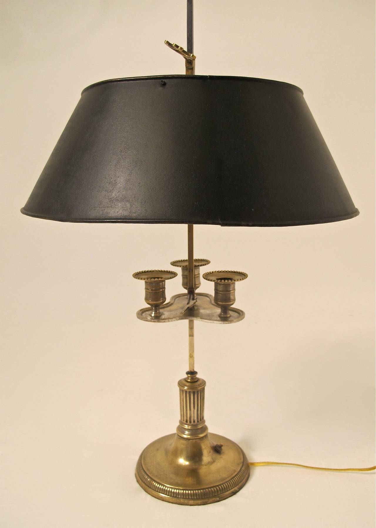 Early 19th century brass candle bouillotte lamp with remnants of silver plate, now converted to electric.