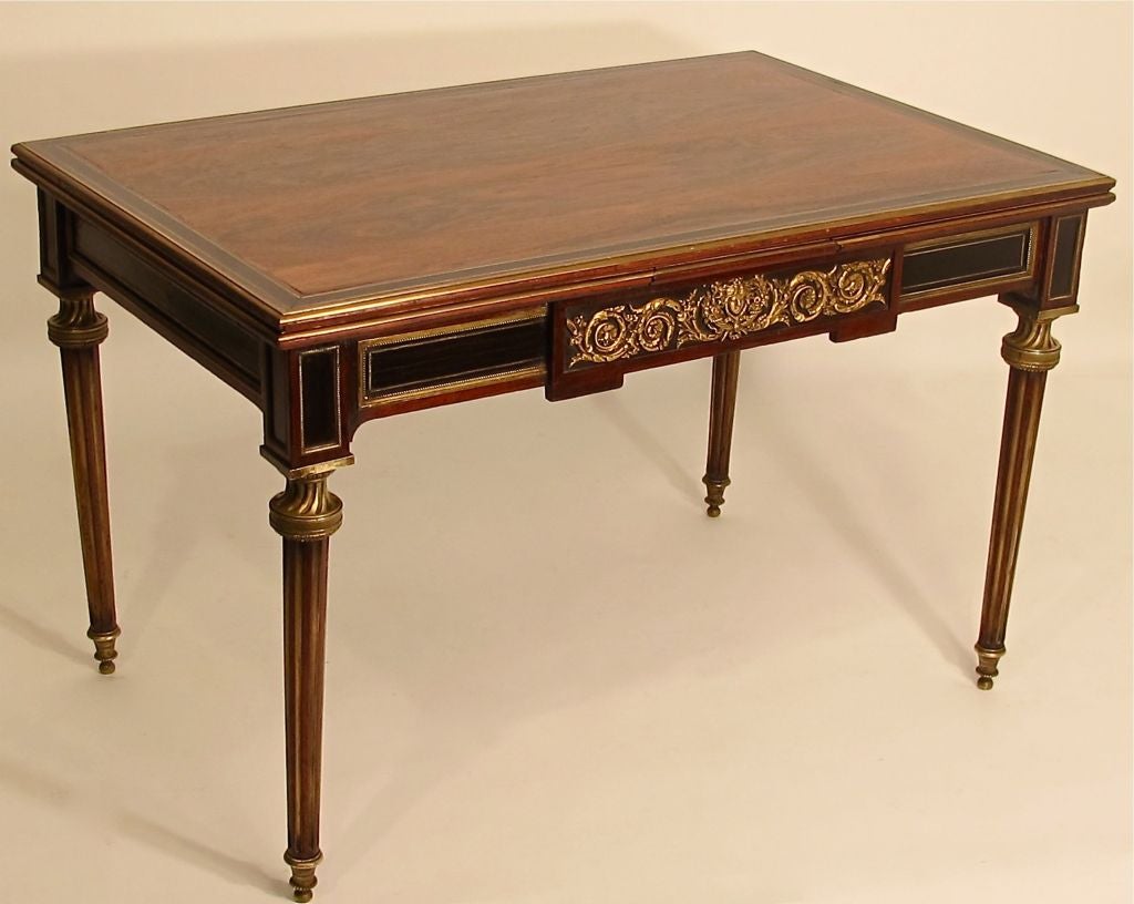 An unusual and elegant 19th century low table or coffee table done in the 18th century Louis XV style. Table has two draw leaves that pull out from either side. When fully opened the table expands to 59.25 inches wide.
Rosewood and ebony with bronze