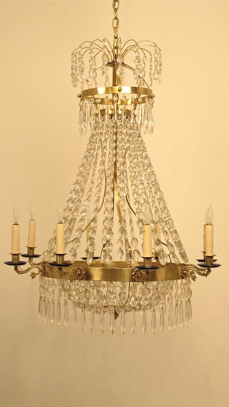 Late 18th/early 19th century brass chandelier with crystal and glass. Originally this light held candles, now electrified with French wiring and professionally restored. Cobalt blue glass bobeches recently added.