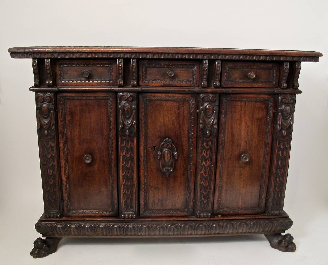 17th century (late Renaissance) Tuscan hand-carved walnut credenza or buffet. Very old if not original finish, minor old repairs and replaced parts, beautiful antique condition.