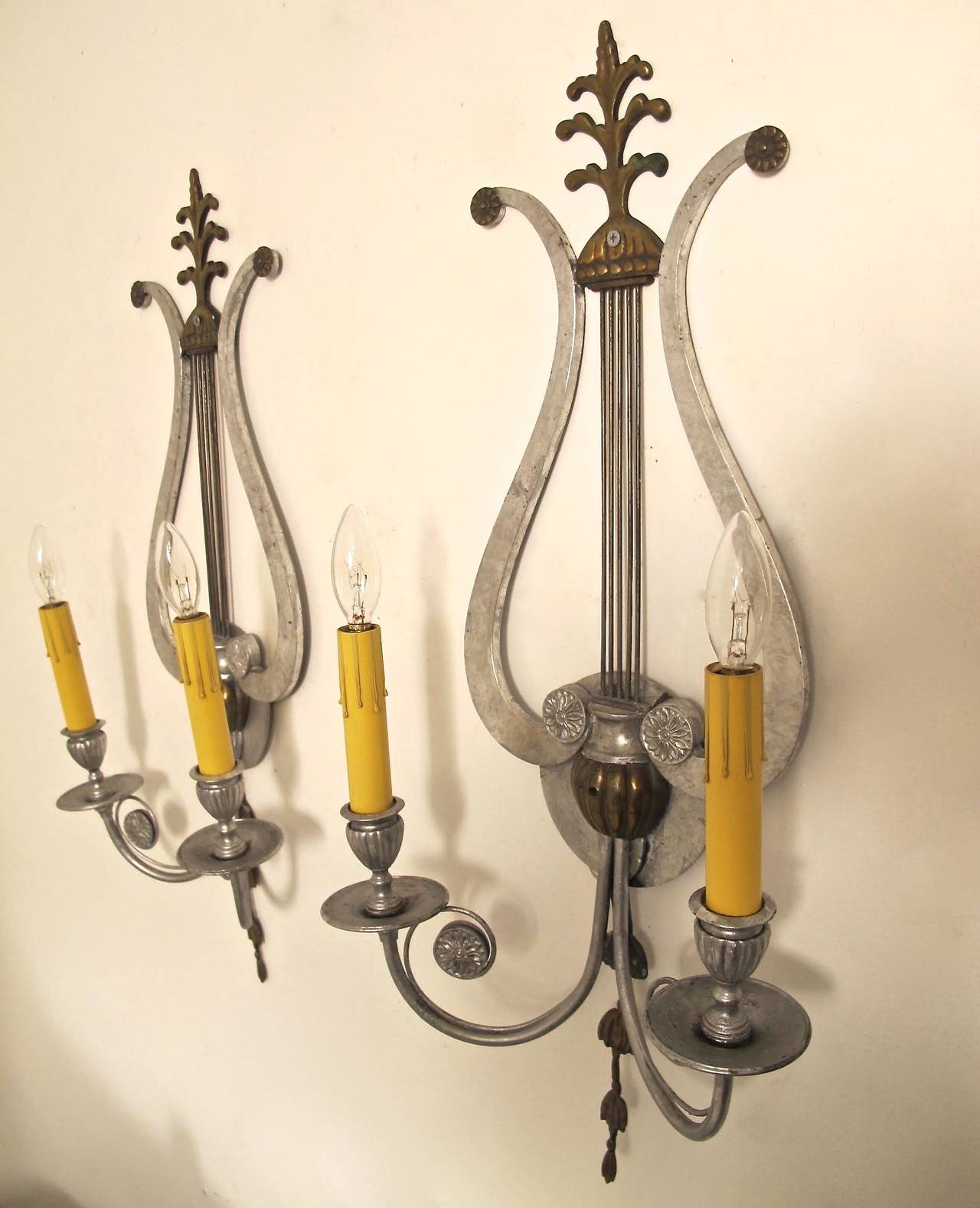 Pair of Neoclassical Lyre shaped silver painted over brass two light sconces.  Recently re-wired.  American, Early 20th. Century. 